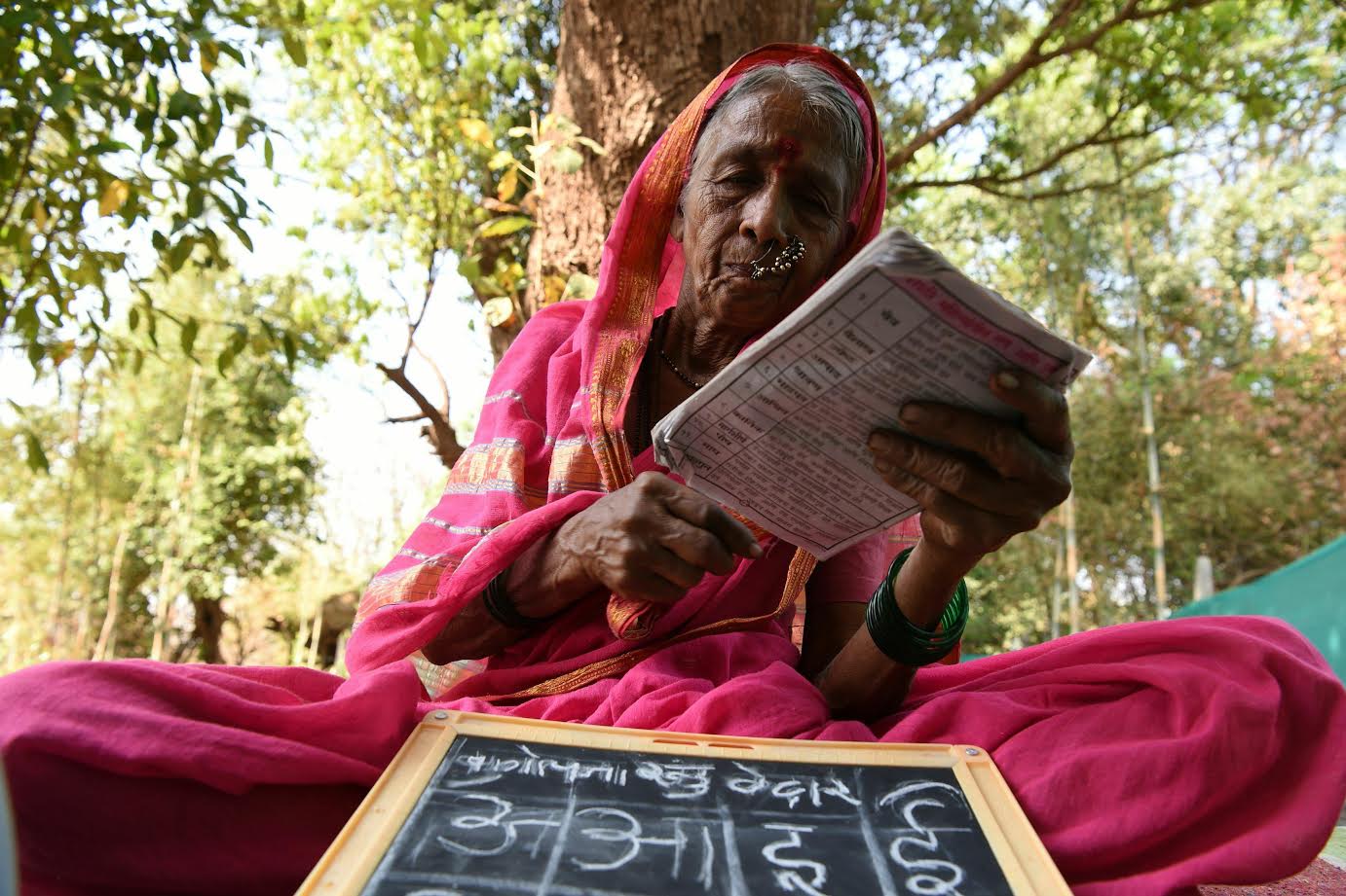 Indian grandmother Sulochona Kedar, 68, reading from a textbook during a class at Aajibaichi Shala, or &quot;school for grannies&quot; in the local Marathi language, in Phangane village in Maharashtra state's Thane district, some 125km northeast of Mumbai. (AFP)